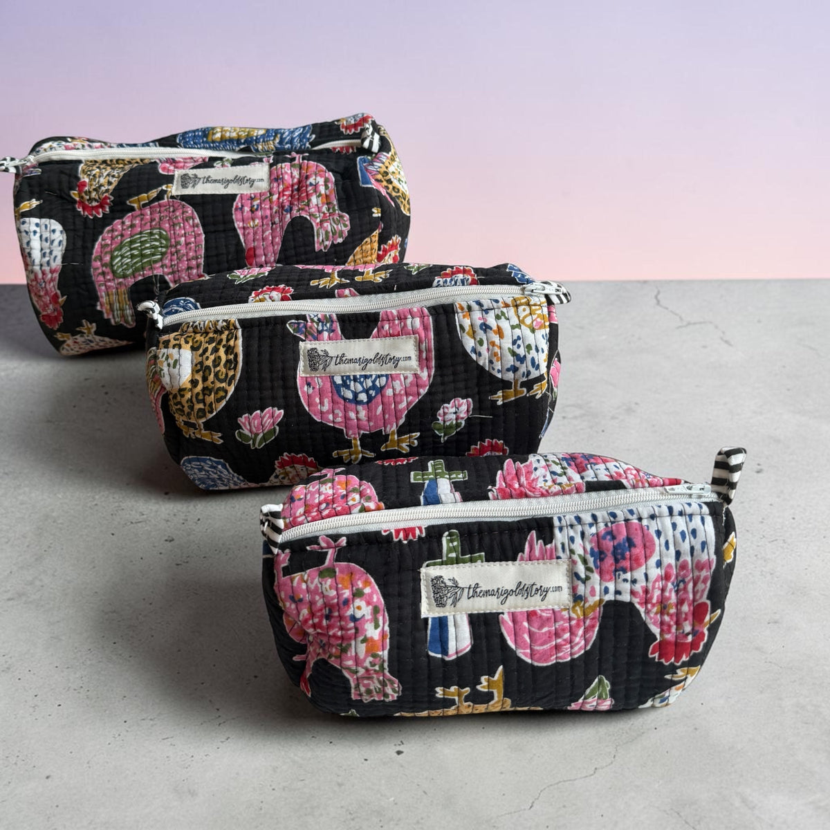 The Marigold Story set of three black quilted cotton pouches with colourful hand-blocked rooster and hen prints.