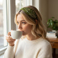 The Marigold Story forest green headband with white floral embroidery and crystal embellishments.