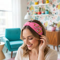 The Marigold Story pink headband with hand-embroidered golden banana motifs