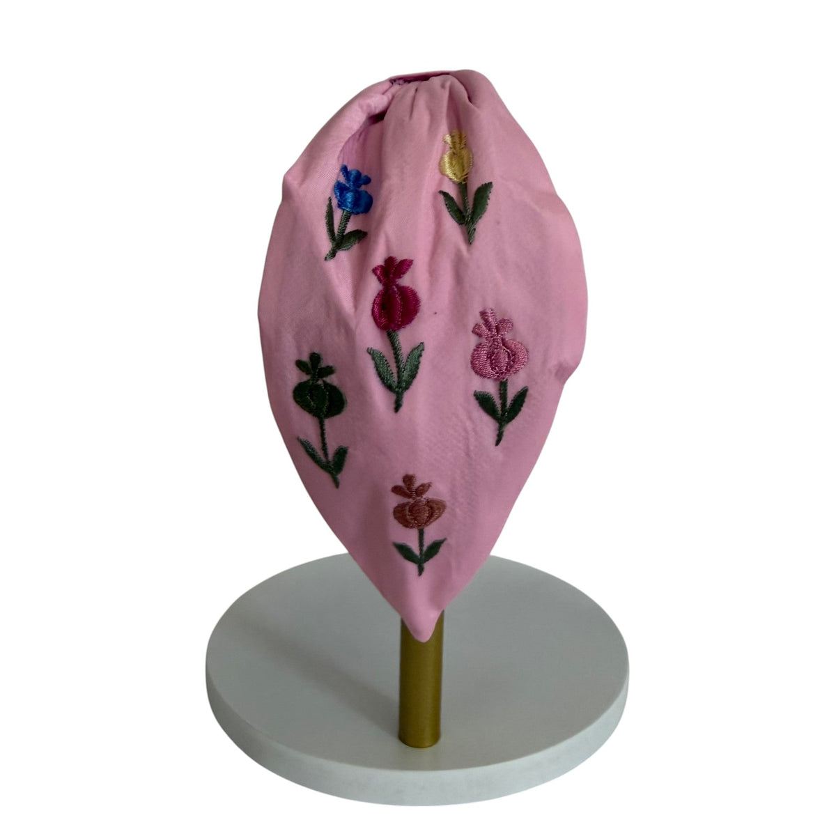 The Marigold Story pink padded headband featuring handcrafted multi-colour tulip embroidery on a soft fabric base.